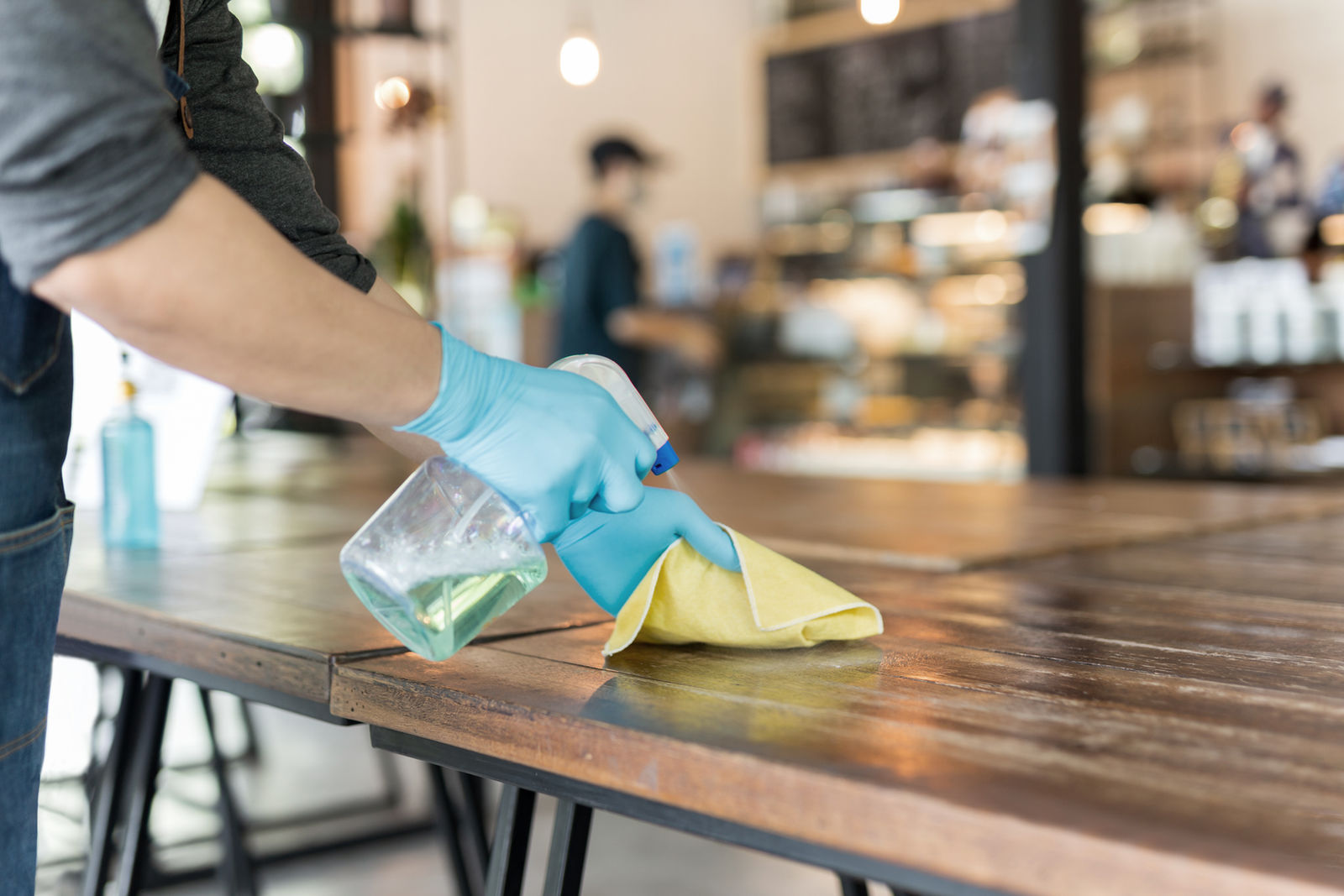 Hand sanitising a commercial dining table